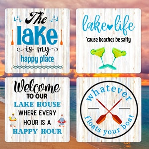 May include: Four wooden signs with lake-themed sayings. The first sign says "The lake is my happy place". The second sign says "lake life 'cause beaches be salty". The third sign says "Welcome to our lake house where every hour is a happy hour". The fourth sign says "whatever floats your boat".