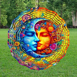 May include: A colorful metal wind spinner with a design of a sun and moon with intricate details. The sun is yellow and orange with flowers and the moon is blue and purple with swirls.