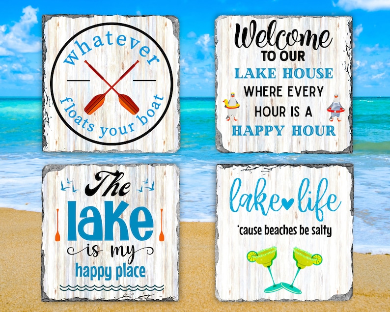 May include: Four wooden signs with whitewash paint and distressed lettering. The signs feature lake-themed sayings: "Whatever floats your boat", "Welcome to our lake house where every hour is a happy hour", "The lake is my happy place", and "Lake life 'cause beaches be salty".