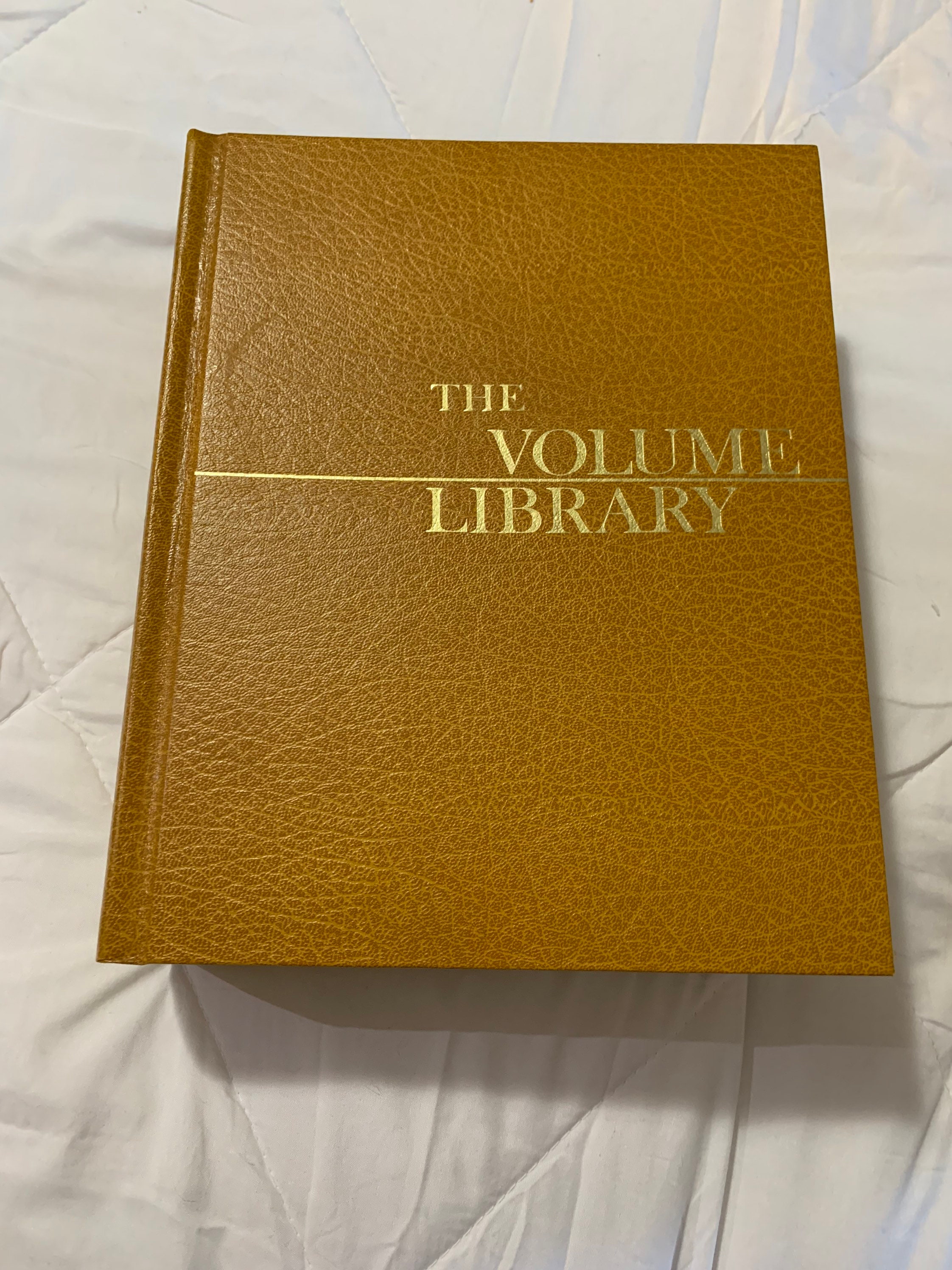 Vintage book, home encyclopedia called The Volume Library with amber