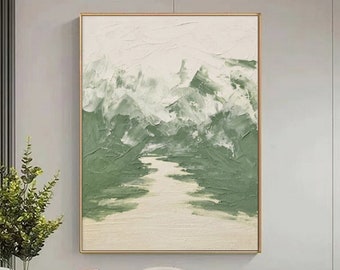 May include: Abstract painting of a green landscape with white mountains and a river. The painting is framed in a gold frame and hangs on a white wall.
