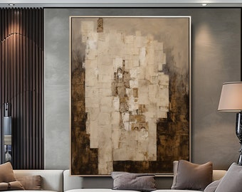 May include: Abstract painting in shades of brown and white with a textured, layered effect. The painting is displayed on a wall in a modern living room setting with a white sectional sofa and a black coffee table.