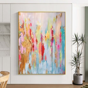 May include: Abstract painting with a colorful, layered design. The painting features shades of pink, blue, yellow, green, and red. The background is a light blue color. The painting has a textured, brushstroke effect.