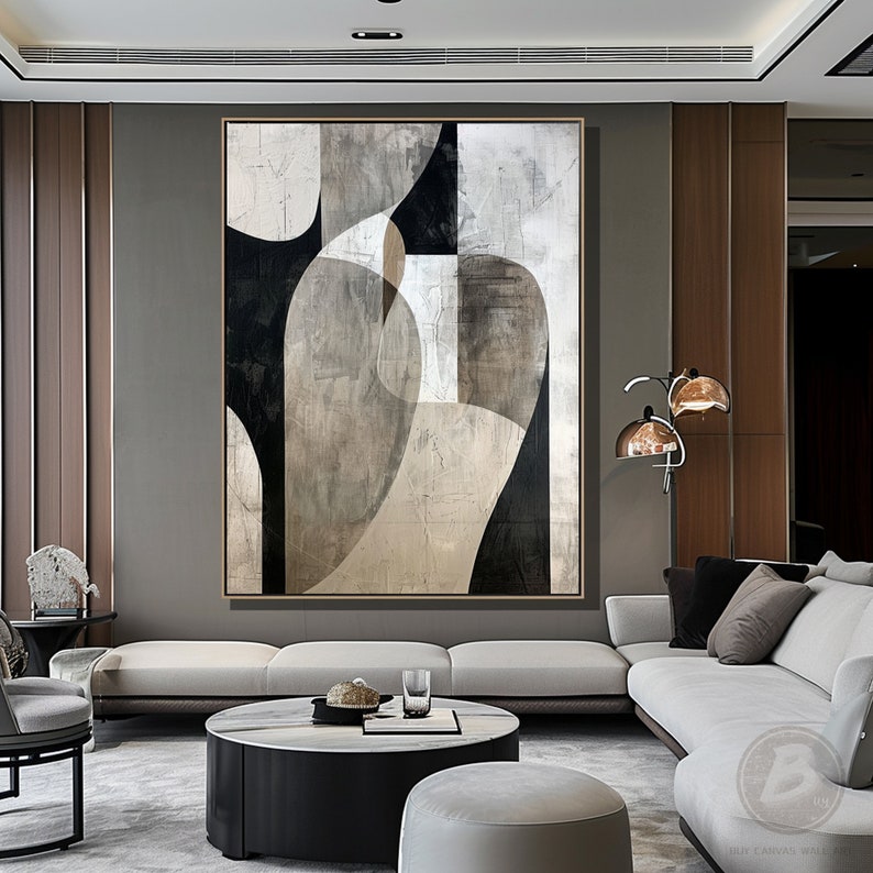 May include: Abstract art painting with geometric shapes in black, white, and gray tones. The painting is displayed on a wall in a modern living room setting.