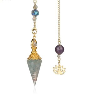 May include: A gold-colored pendulum with a faceted, light blue-green crystal point. The pendulum features a gold-colored chain with a faceted crystal and a gold-colored lotus charm. The pendulum is designed for spiritual practices.