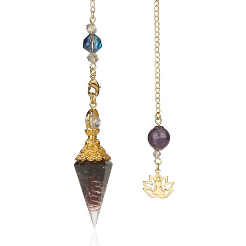 May include: Two pendulums on gold chains. One features a faceted, clear-tipped crystal with a gold filigree cap and blue and clear beads. The other has a purple sphere and a gold lotus charm.