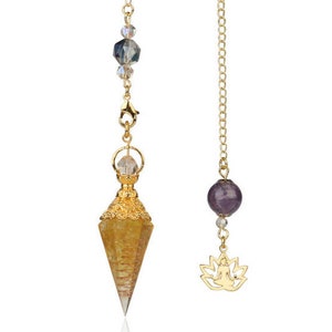 May include: Two pendulums with gold chains. One features a yellow crystal point with gold filigree and clear beads. The other has a purple sphere, clear beads, and a gold lotus charm. Both are designed for spiritual practices.