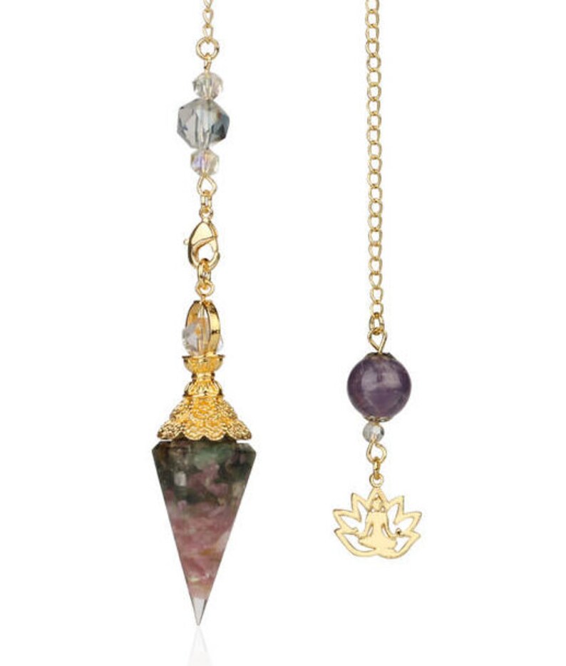 May include: Two pendulums with gold chains. One features a faceted, multi-colored crystal point with gold filigree and clear beads. The other has a purple gemstone and a gold lotus flower charm.