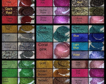 May include: A variety of glitter colors in small containers, including purple, pink, red, green, blue, gold, and silver. The glitter is arranged in a grid pattern with the color names listed below each container.