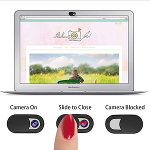 May include: A black webcam cover with a sliding mechanism to block the camera lens. The cover is shown on a laptop with the text "Camera On", "Slide to Close", and "Camera Blocked" above it.