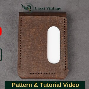 May include: A brown leather wallet with a white card slot. The wallet is stitched with brown thread and has a rectangular shape. The image also includes a YouTube logo, a plus sign, and a PDF icon with the text "Pattern & Tutorial Video".