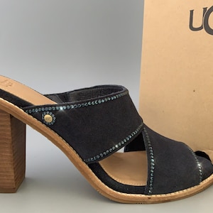 May include: Black suede heeled sandals with a wooden heel and a decorative band of blue rhinestones.