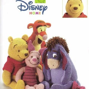 May include: A collection of crocheted Disney characters, including Winnie the Pooh, Tigger, Piglet, and Eeyore. The characters are in various colors, such as yellow, red, pink, and purple. The image also features the Disney Home logo.