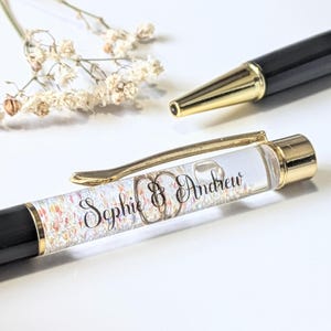 May include: A distressed white wooden sign displaying the word "Welcome" in a handwritten font. The sign has a rustic appearance with a floral embellishment. The background is a blurred wooden texture.