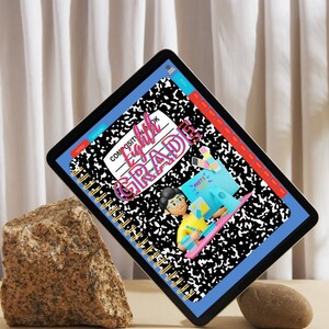 May include: A digital tablet displaying a blue and black composition notebook cover with the text "Composite Notebook Eighth Grade" and a cartoon illustration of a person sitting at a desk with a computer. The notebook cover has a black and white speckled pattern.