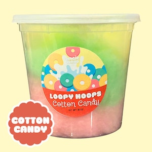 May include: A clear plastic container filled with three layers of cotton candy. The bottom layer is pink, the middle layer is green, and the top layer is yellow. The container has a label that says "Loopy Hoops Cotton Candy" and "Magic Wand".
