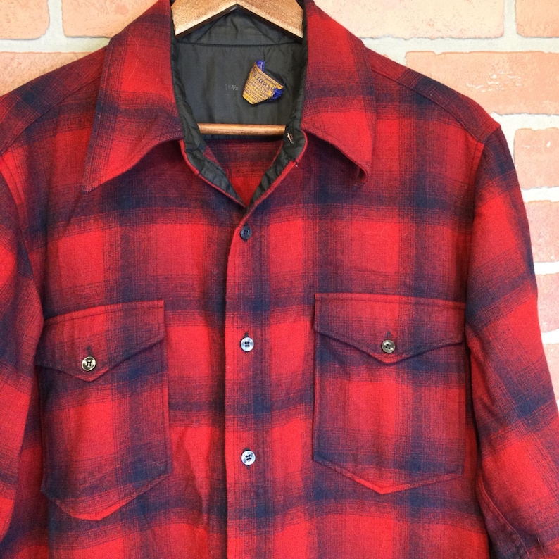 May include: A white ceramic mug with a black handle and the text "But First, Coffee" in a handwritten style. The mug is on a white surface. The mug is approximately 4 inches tall.