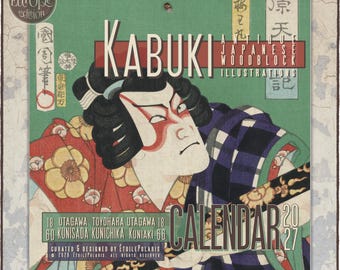 May include: A 2027 wall calendar featuring Kabuki antique Japanese woodblock illustrations. The cover displays a stylized actor with black hair and red makeup, wearing a red floral and blue checkered robe, with text including KABUKI and 2027.