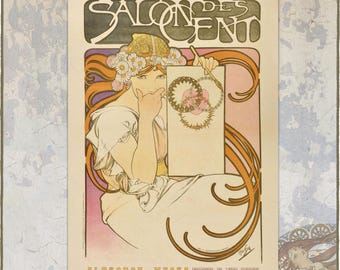 May include: A 2027 wall calendar featuring an Alphonse Mucha illustration of a person with long orange hair adorned with white flowers. The text SALON DES CENT is at the top, and the bottom includes ALPHONSE MUCHA CALENDAR 2027 and ETOILE POLARIS.
