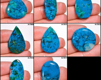 Könnte beinhalten: Eine Sammlung polierter Edelsteine in verschiedenen Formen, darunter oval, tropfenförmig und rund. Die Steine zeigen eine lebendige türkisfarbene Farbe mit komplizierten dunkelblauen und grünen Aderzeichnungen. Jeder Stein ist einzigartig.