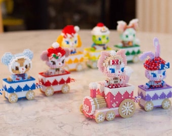 May include: A set of seven colourful, beaded train carriages featuring cartoon animal characters. Each carriage has a different animal, including a bear, a cat, a rabbit, and a bird. The train carriages are decorated with snowflakes and other winter-themed details.