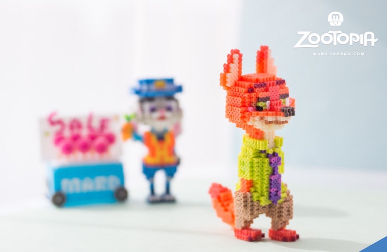 May include: A red fox character with a green shirt and purple tie, made of colorful plastic beads. The character is from the animated movie Zootopia.