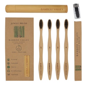 May include: A set of four bamboo toothbrushes with black bristles, a travel case, and a small container of floss. The packaging is brown with the text "Bamboo Valley" and "Jungle Brush".