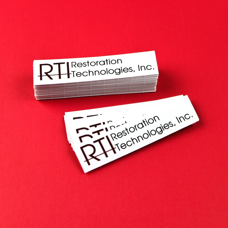 May include: A stack of white business cards with the text "RTI Restoration Technologies, Inc." printed in black.