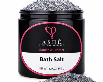 May include: A black jar of bath salts with a pink and white label. The label reads "ASHÉ SPIRITUAL SKINCARE, Banish & Protect, Bath Salt, NET WT. 12 OZ | 340 g." The jar is filled with clear and blue crystals.