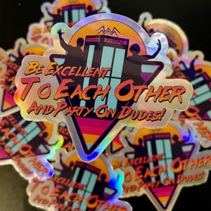 May include: A holographic sticker with a retro design featuring two figures in front of a phone booth with the text "BE EXCELLENT TO EACH OTHER AND PARTY ON DUDES!"