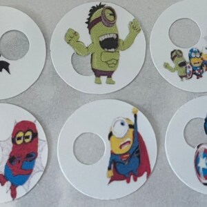 May include: Six round white stickers featuring various superhero-themed images of a minion. Each sticker has a hole in the centre. The images include a minion dressed as Batman, Hulk, Superman, Spiderman, Captain America, and a group of minions dressed as superheroes.