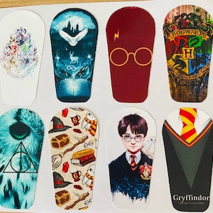 May include: Eight Harry Potter themed stickers featuring different house crests, characters, and symbols. The stickers are printed on white backgrounds and have a glossy finish.