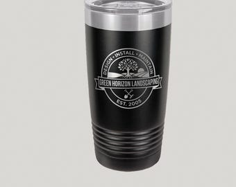 May include: Black insulated tumbler with a clear lid and silver rim. The tumbler features the Green Horizon Landscaping logo in a circular design. The logo includes a tree, the words "Design, Install, Maintain," and "Est. 2005."