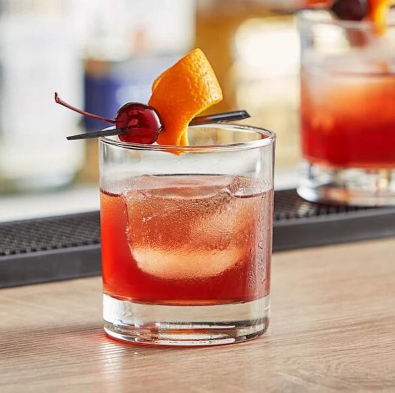 a close up of a drink in a glass on a table