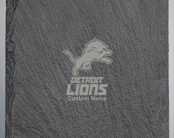 May include: A gray slate coaster with a Detroit Lions logo and the text "DETROIT LIONS Custom Name".