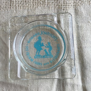 May include: A clear glass ashtray with a blue circle design featuring the text "Howard Johnson's" and "Cream Tops and Fried Clams".