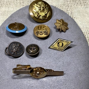8 Piece Variety of Military Gold Tone Lapel Pins, Buttons and Tie Clip