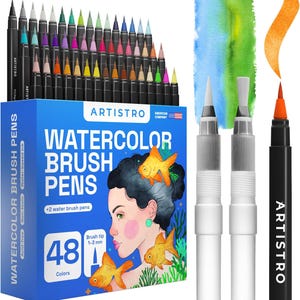 May include: A set of 48 Artistro watercolor brush pens in a blue box featuring an illustration of a person and goldfish. The set includes two clear water brush pens and one orange brush pen with a 1-3 mm tip, shown with a painted orange stroke.