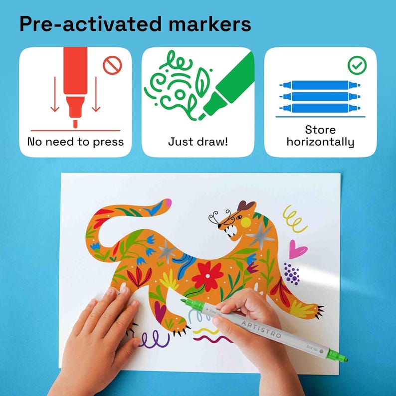 May include: A child's hand colors a drawing of a colorful orange and yellow jaguar with green, purple, and pink flowers on a white sheet of paper using a dual-tip marker pen labeled "ARTISTRO".