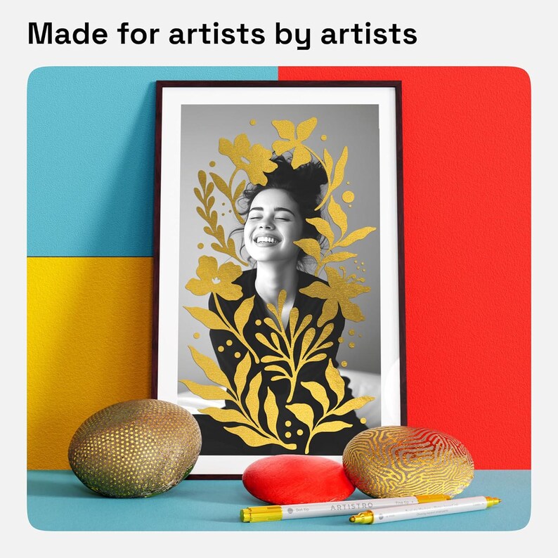 May include: A framed black and white photo of a woman with gold leaf floral designs. The photo is displayed on a table with two decorative gold and brown stones and a red stone.