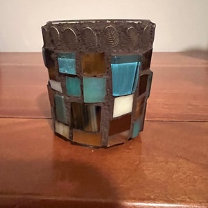 Brown, bronze, and turquoise mosaic tea light holder.