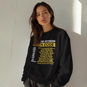 May include: Black sweatshirt with the text "OR CITIZEN TECH CODE" in white and yellow. Below the title are a series of acronyms and phrases, including "Still Searching for Dentures" and "Really Technically Yucky".