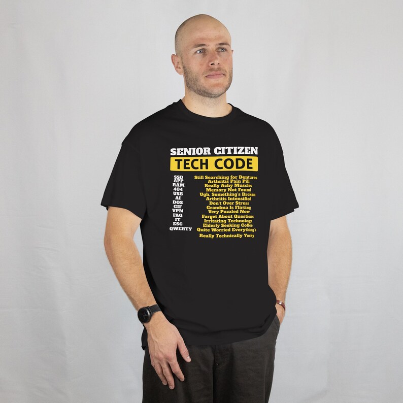 May include: Black t-shirt with the text "SENIOR CITIZEN TECH CODE" in white and yellow. The shirt lists humorous tech-related phrases like "Memory Not Found" and "Forget About Questions". The shirt is a humorous gift idea.