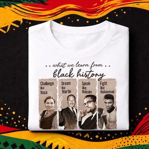 May include: White t-shirt with the text "...what we learn from... black history." The shirt features images of Rosa Parks, Martin Luther King Jr., Malcolm X, and Muhammad Ali, with the phrases "Challenge like Rosa," "Dream like Martin," "Speak like Malcolm," and "Fight like Mohammad."