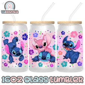 May include: Three 16oz glass tumblers with a pink and blue floral design featuring Stitch and Angel from the Disney movie Lilo & Stitch. Each tumbler has a straw.