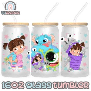 May include: Three 16oz glass tumblers with bamboo lids and clear straws. Each tumbler features a different cartoon character design. One shows a girl in a pink dress, another has a blue monster, and the third has a girl in a purple monster costume.