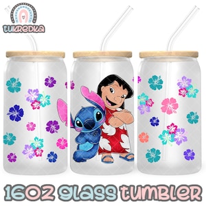 May include: Three 16oz glass tumblers with bamboo lids and clear straws. Each tumbler features a floral pattern with blue, purple, and pink hibiscus flowers. One tumbler has a graphic of Lilo and Stitch. The text "16oz Glass Tumbler" is at the bottom.