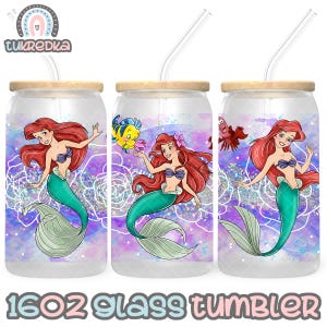 Puede incluir: Tres vasos de vidrio de 16 oz con un fondo de acuarela morado, rosa y azul. Cada vaso presenta una sirena con una cola verde y cabello rojo. Las sirenas sostienen una concha y una estrella de mar. Los vasos tienen una tapa de madera y una pajita.