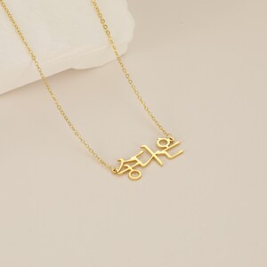 May include: A gold chain necklace with a pendant featuring the Korean word "Freedom" in Hangul.