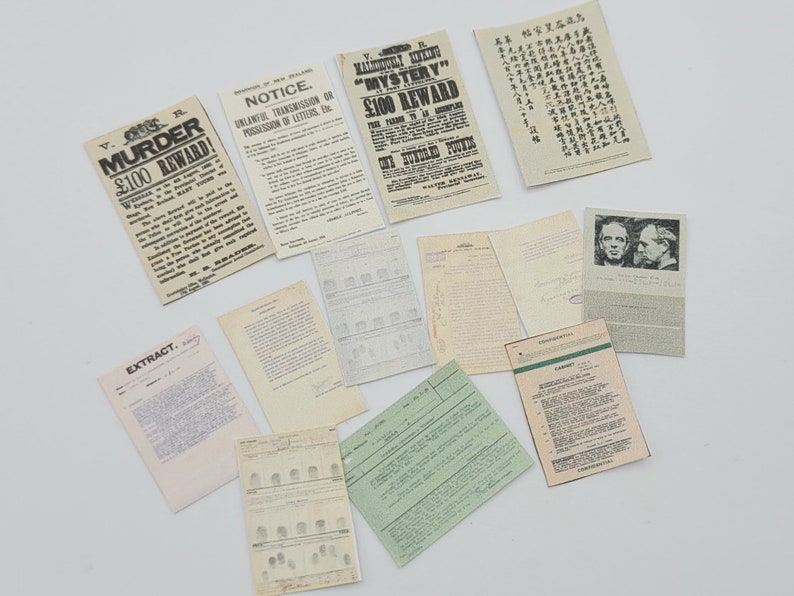 May include: A collection of vintage documents and papers, including a notice about unlawful transmission of letters, a reward poster for a murder case, and a document with fingerprints.
